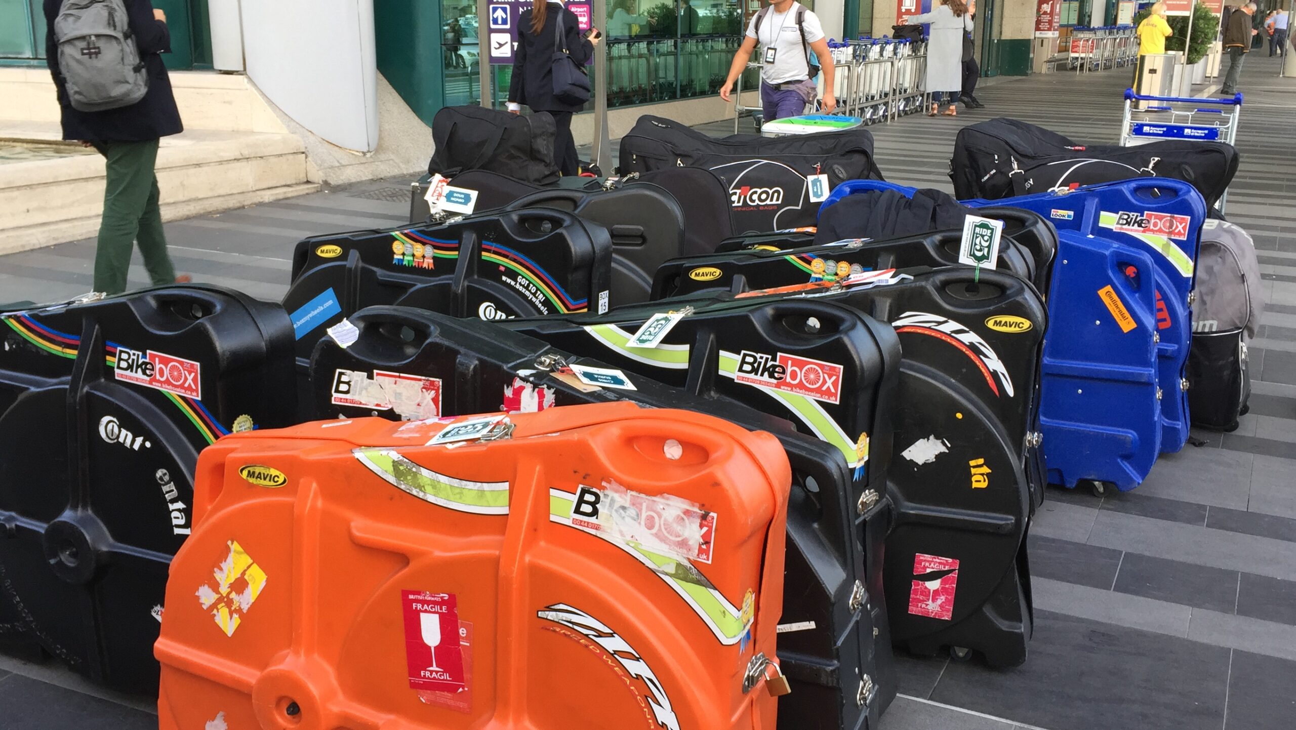 Row of colourful bike boxes outside the airport.