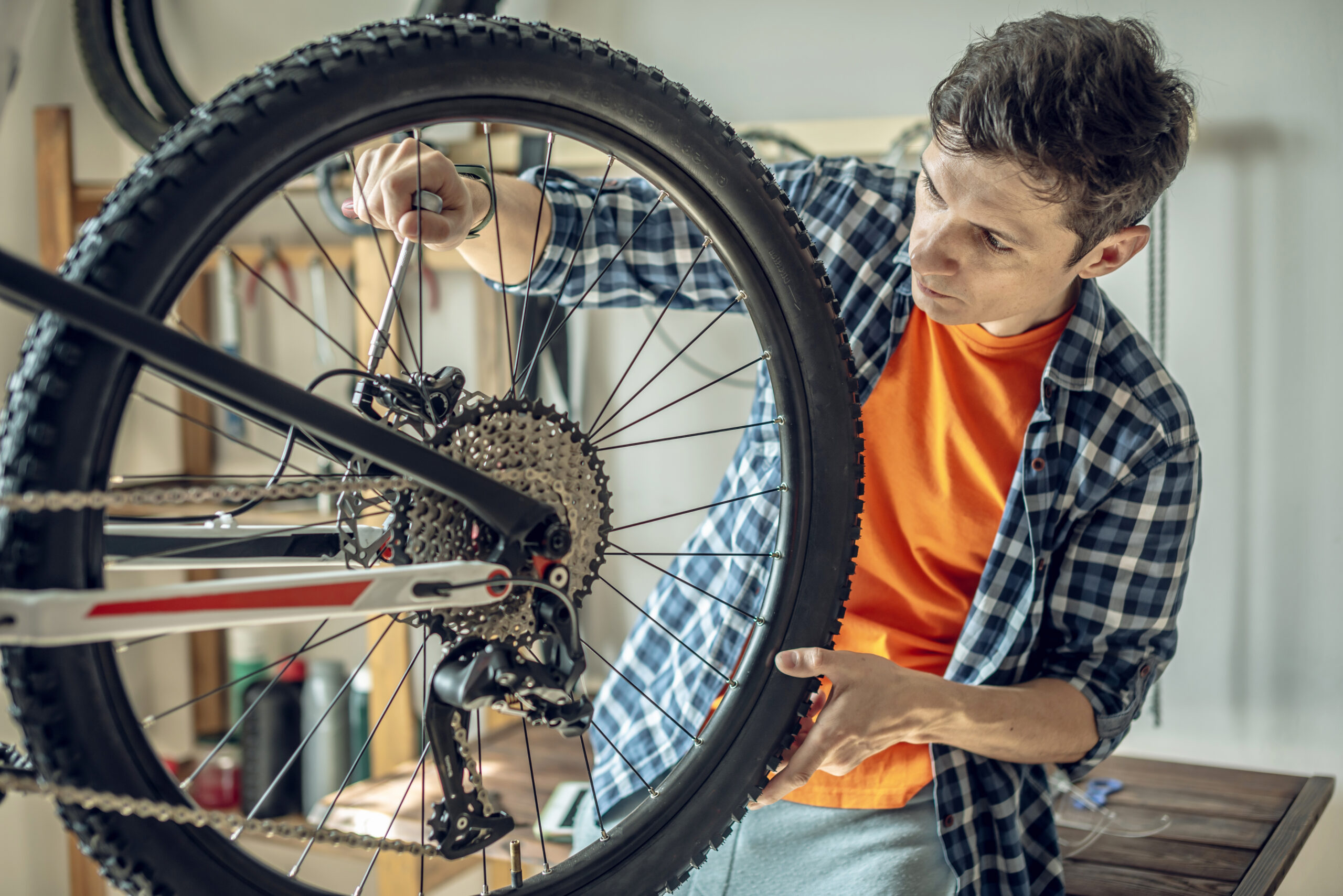 Man repairing a mountain bike in a shop.